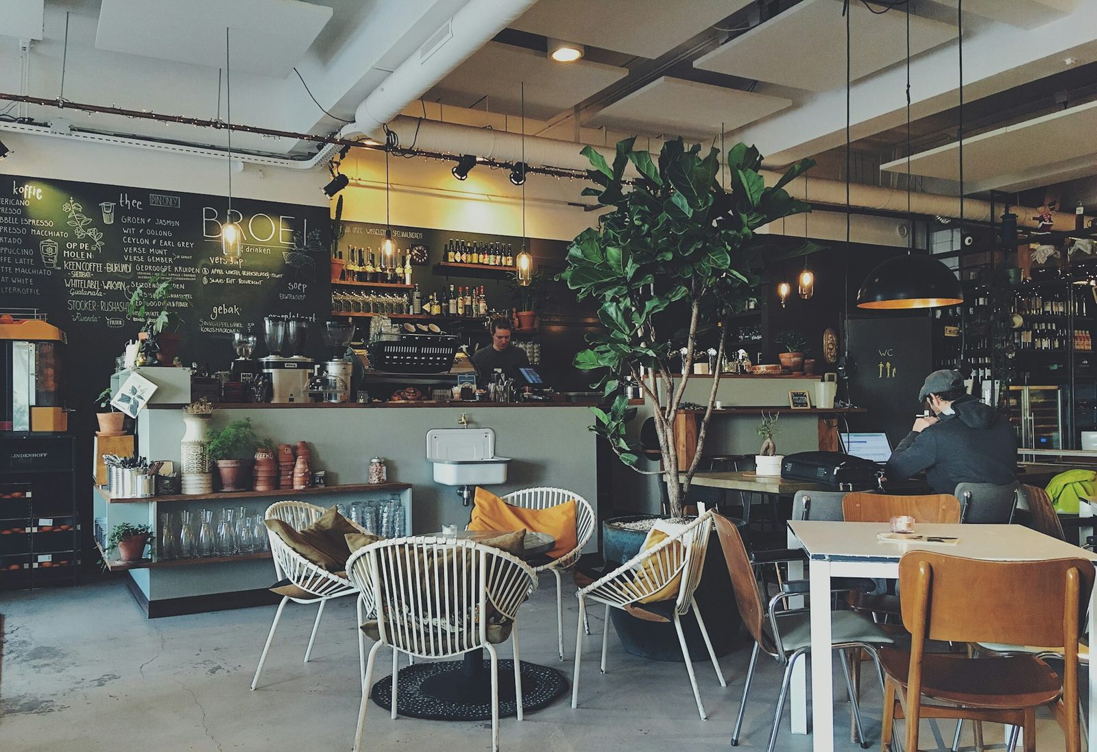 Cafe counter beneath a large handwritten chalkboard menu.